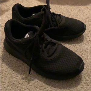 Women’s all black Nike shoes
